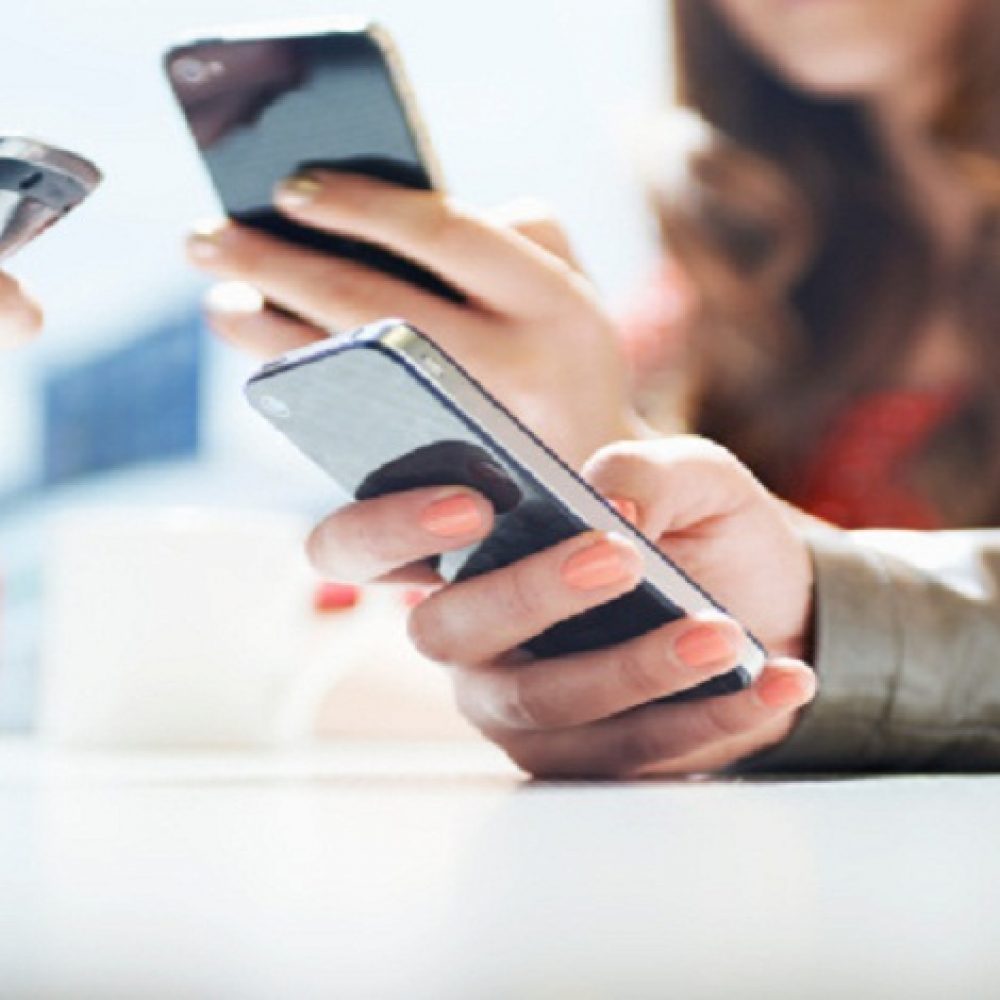 hands texting with mobile phones in cafe